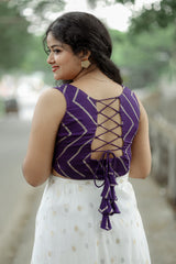 Crop top with lose bottom and a cape around the waist
