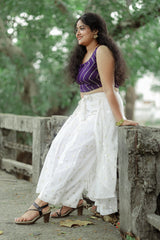 Crop top with lose bottom and a cape around the waist